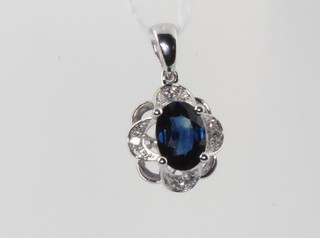 A 9ct white gold oval sapphire and diamond pendant, the centre stone approx 0.75ct 