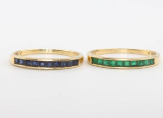 Two 18ct yellow gold channel set emerald and sapphire rings size M 1/2, 3.2 grams