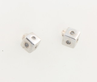 A pair of 9ct white gold square diamond set ear studs 