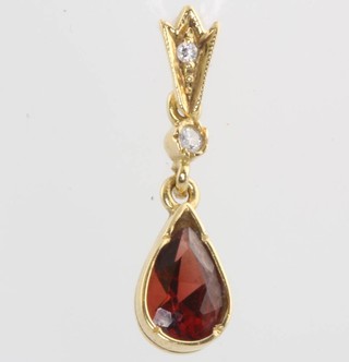 An 18ct yellow gold ruby and diamond pendant 
