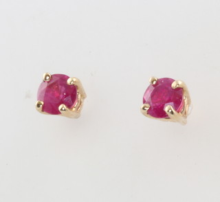 A pair of yellow gold ruby ear studs 4mm 
