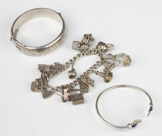A silver bangle, 1 other and a silver charm bracelet, 104 grams 