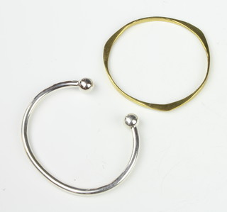A silver torque bangle and 1 other bangle