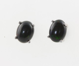 A pair of silver black Ethiopian opal studs  