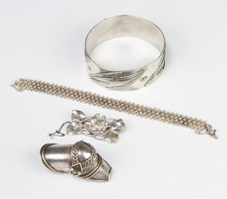 A silver bangle and minor silver jewellery 127 grams