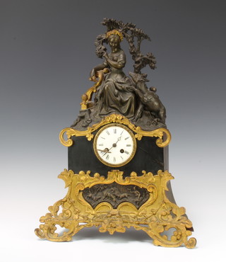 Janvier Paris, a French 19th Century striking mantel clock with silk suspension and enamelled dial with Roman numerals, contained in a bronze and gilt bronze case surmounted by a figure of a seated girl with dog 