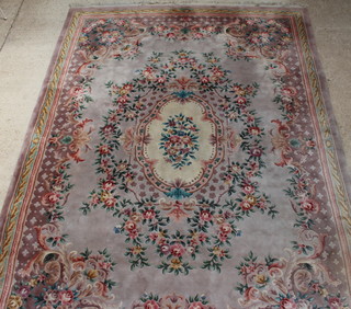 A dusky pink and floral patterned Chinese carpet with central medallion 438cm x 307cm 