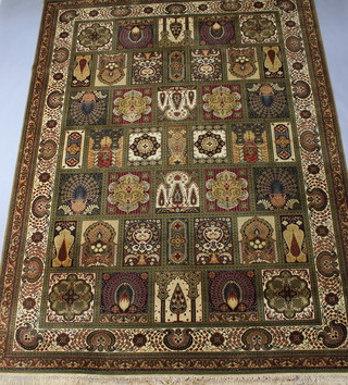 A green ground Persian machine made carpet, the central ground formed of 41 panels 360cm x 275cm 