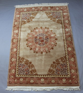 A peach ground and floral patterned Chinese rug with central medallion 314cm x 238cm 