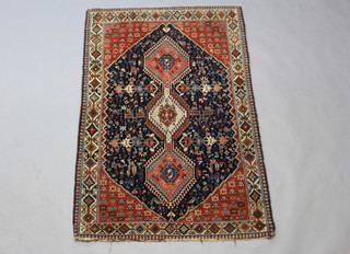 A blue and red ground Persian carpet with 3 stylised diamond medallions to the centre within a multi row border 167cm x 107cm 