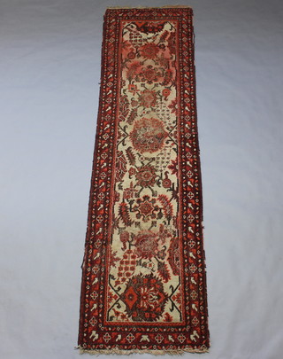 A red and white ground Turkey style runner with 6 medallions to the centre within a multi row border 338cm x 94cm 