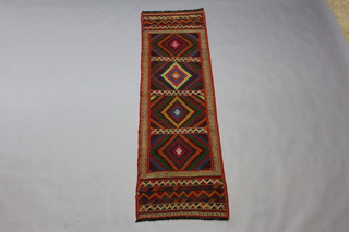 A multi coloured Suzni Kilim runner with 4 panels to the centre with a diamond field 210cm x 65cm