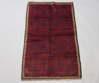A blue and red ground Belouche rug with numerous diamonds to the centre 145cm x 90cm 