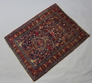 A red and blue ground Dorokhsh rug with vase motif to the centre 131cm x 104cm 