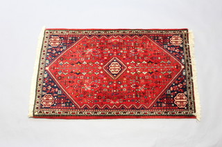 A red and blue ground Persian Abadeh rug with central diamond shaped medallion 124cm x 78cm 