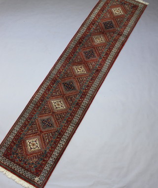 A blue, white and green ground Bidjar runner with 9 octagons to the centre within a 3 row border 408cm x 92cm 