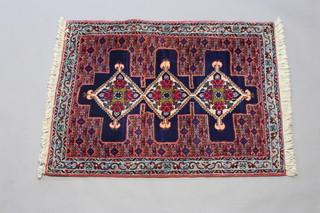 A blue and red ground Persian Senneh rug with 3 diamond medallions to the centre 104cm x 79cm 