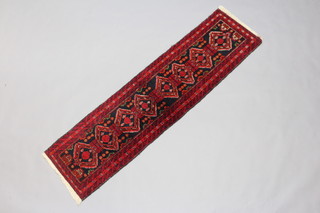 A black and red ground Tekke Torkman runner with 8 diamonds to the centre within a multi row border 