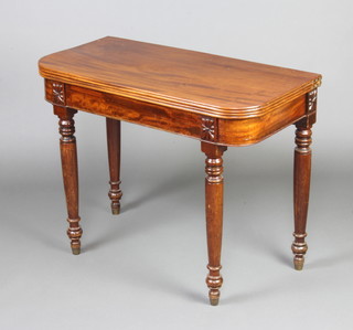 A 19th Century D shaped card table raised on turned supports 72cm x 91cm x 45cm 