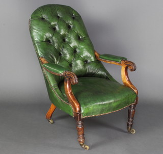 A William IV bleached mahogany open armchair upholstered in green buttoned material, raised on turned supports 