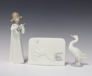 A Lladro figure of a girl playing a mandolin 21cm, a ditto of a goose 12cm together with a Lladro Collectors Society plaque 