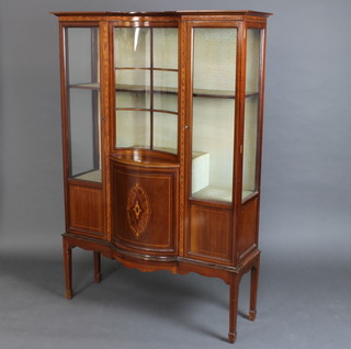 An Edwardian inlaid mahogany display cabinet, the centre section with concave panel flanked by a pair of cupboards enclosed by glazed panelled doors, raised on square tapered supports, spade feet 168cm h x 1015cm w x 35cm d 