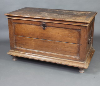 An 17th/18th Century Continental oak coffer of panelled construction with hinged lid and iron drop handles to the sides, raised on bun feet 73cm h x 120cm w x 64cm d 