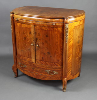 A Continental D shaped inlaid mahogany drinks cabinet, the top crossbanded and inlaid a vase of flowers, fitted a brushing slide and cupboard enclosed by an inlaid tambour shutter, base fitted a drawer and raised on cabriole supports 104cm h x 104cm w x 60cm d 
