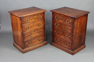 A pair of Ipswich style oak bedside chests of 4 long drawers with brass swan neck drop handles, raised on a platform base 79cm h x 63cm w x 45cm d  