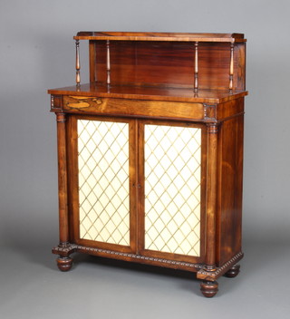 A Regency rosewood chiffonier with raised back, the base fitted a drawer above a cupboard enclosed by a pair of grilled panelled doors, raised on bun 123cm h x 92cm w x 39cm d  