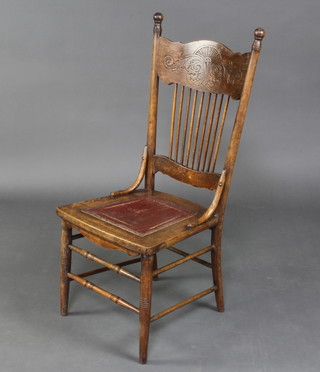 An American elm carved stick and bar back chair raised on turned supports