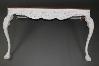 A Rococo style carved walnut and white painted console table raised on cabriole supports 82cm h x 144cm w x 44cm d 
