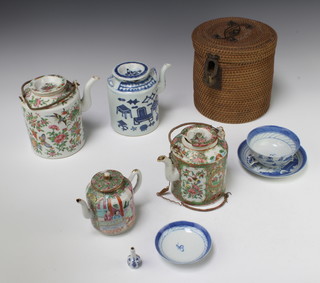 A 19th Century Cantonese teapot and cover decorated with panels of figures in pavilions and birds 13cm, a later ditto in a wicker basket, a similar teapot, a blue and white ditto, tea bowl, saucer and lid and a miniature vase