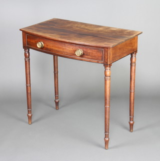 A Georgian mahogany bow front side table fitted a drawer, raised on turned supports 80cm h x 83cm w x 48cm d 