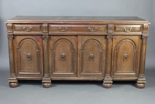 Liberty and Company, a carved oak sideboard fitted 1 long flanked by 2 short drawers above a triple cupboard with column decoration and Ionic capitals 90cm h x 182cm w x 58cm d, raised on bun feet, labelled Liberty and Co, Regent Street, London, to the back   