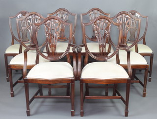 A harlequin set of 8 Hepplewhite style shield back dining chairs comprising 2 carvers, 6 standard, with upholstered drop in seats on square tapered supports, spade feet 