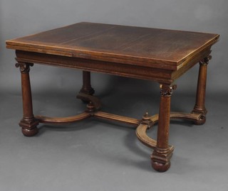 Liberty and Company, a 1920's Continental style oak draw leaf dining table, raised on turned columns with Corinthian capitals and Y framed stretcher with bun feet, the base labelled Liberty and Co Regent Street, London, 77cm h x 130cm when closed x 245cm when extended x 107cm w   
