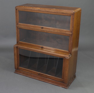 An Art Deco oak 3 tier Globe Wernicke style bookcase, the base fitted record dividers and with reeded decoration 108cm h x 90cm w x 37cm d 