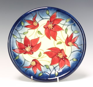 A modern Moorcroft plate decorated with flowers, impressed marks, dated 2002, 26cm 