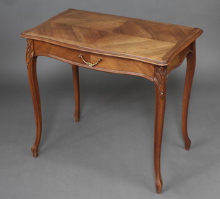 A French walnut side table of serpentine outline with quarter veneered and crossbanded top fitted a frieze drawer, raised on carved cabriole supports 73cm h x 78cm w x 47cm d 