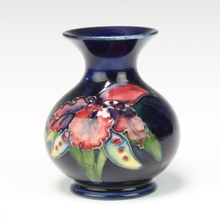 A Moorcroft bulbous vase decorated the iris pattern on a blue ground impressed marks 9cm 