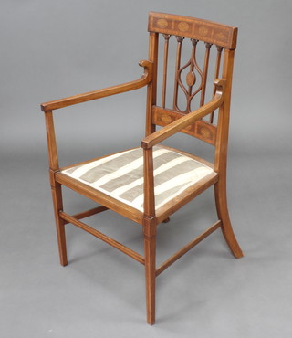 An Edwardian Art Nouveau inlaid mahogany stick and bar back open arm chair with upholstered seat raised on square tapered supports 
