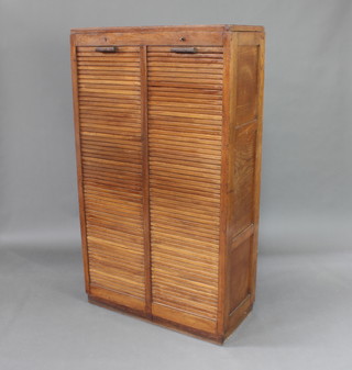 A 1930's oak filing cabinet fitted trays enclosed by tambour shutters 155cm h x 86cm w x 40cm d 