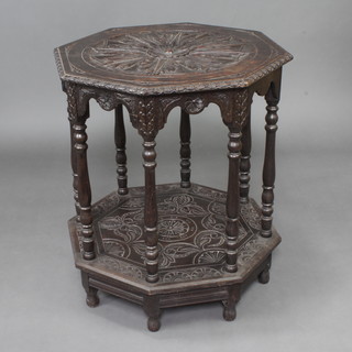 A Victorian hexagonal carved oak 2 tier occasional table, raised on turned supports with bun feet 77cm h x 64cm w x 66cm d