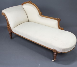 A Victorian inlaid walnut chaise longue upholstered in yellow material, raised on turned supports 93cm h x 188cm w x 65cm d 