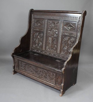 A Victorian oak settle heavily carved throughout 130cm h x 122cm w x 52cm d  