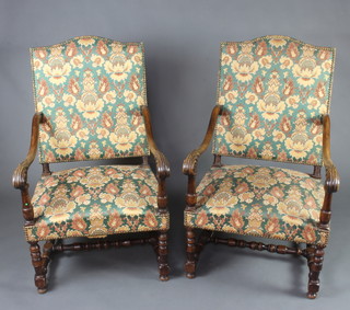 A pair of 17th Century style carved walnut open arm chairs with upholstered seats and backs, raised on turned supports with an H framed stretcher 