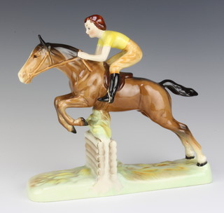 A Beswick figure of a girl on a jumping horse no.939 by Arthur Greddington, brown gloss, 24.7 cm 