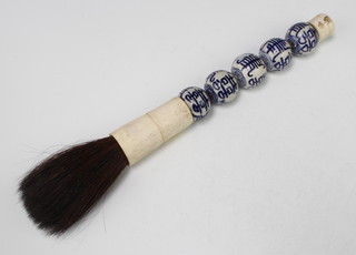 A modern Chinese porcelain handled calligraphy brush 41cm
