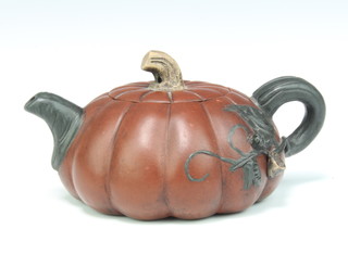 A tan ware melon shaped teapot decorated with leaves, having a character mark to base 10cm 